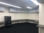 Carpeted office space with lighting