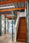 Stair access to upstairs office with storage mezzanine structure